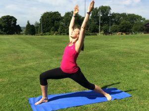 Tabitha Wright, yoga teacher at Tabitha Yoga standing in Warrior 1 yoga pose designed to transform your body