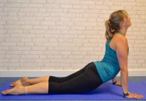 Tabitha Wright yoga teacher at Tabitha Yoga laying in an Upward Dog back bend yoga pose designed to transform your body