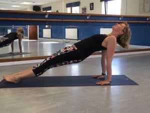 Tabitha Wright yoga teacher at Tabitha Yoga practising a reverse plank yoga pose designed to transform your body