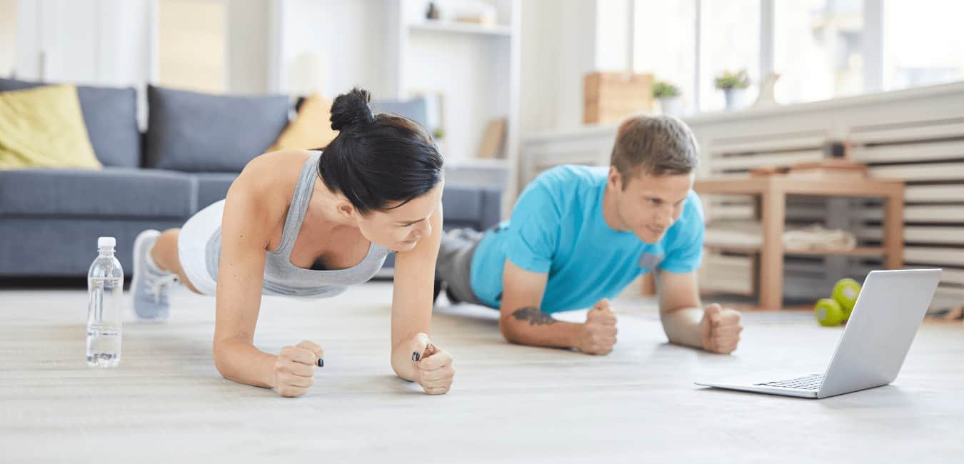 man and woman exercising at home online