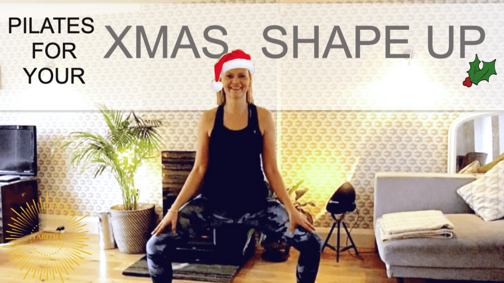 Tabitha Yoga standing in a yoga pose in a Christmas hat for Pre Christmas Shape Up video class