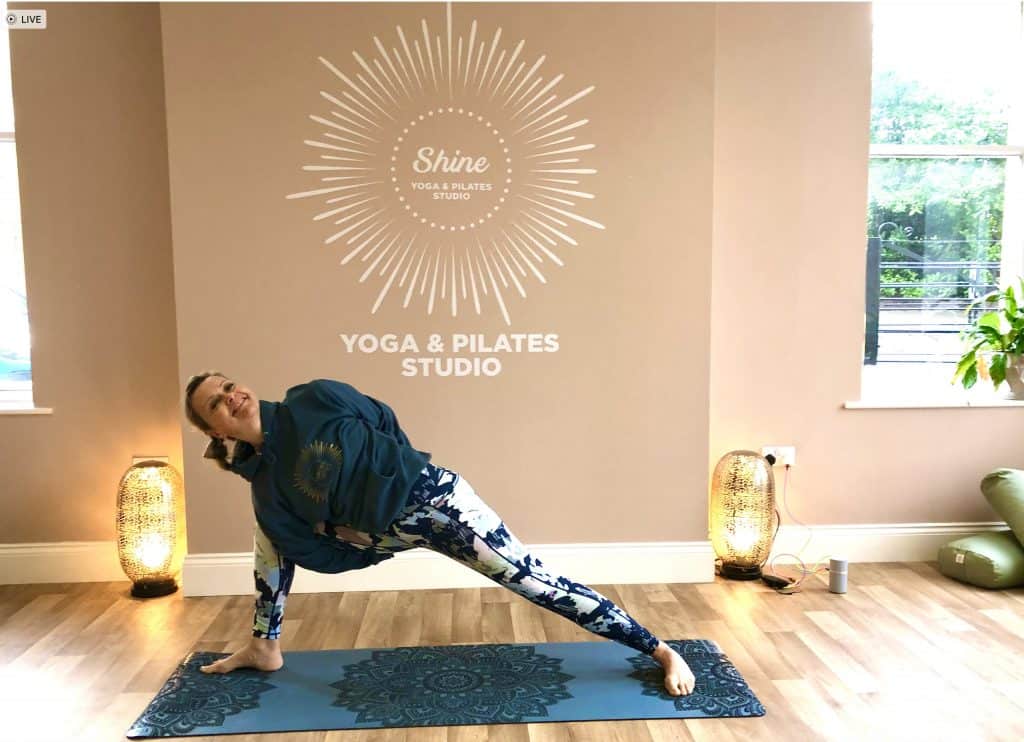 tabitha Wright in a yoga bind pose in shine With Tabitha Yoga Srudion